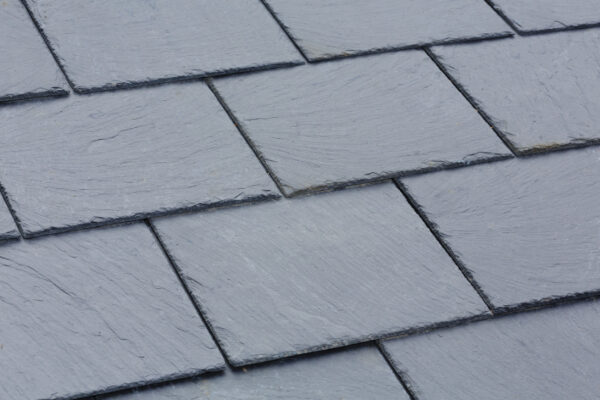 Closeup of traditional grey slate roof tiles on a pitched roof