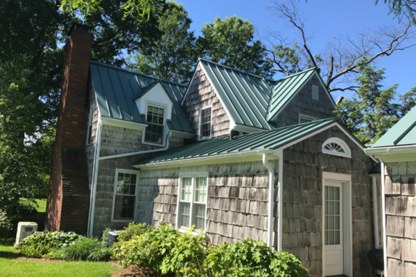 Standing Seam Metal roof with gutters on farmhouse